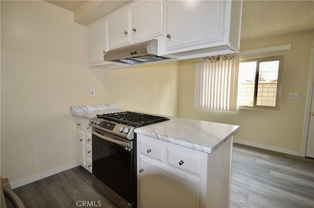 kitchen with dark wood-type flooring, gas stove, white cabinetry, light stone counters, and a textured ceiling