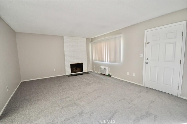 unfurnished living room featuring carpet floors and a brick fireplace