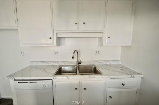 kitchen with light stone counters, sink, white cabinets, and dishwasher