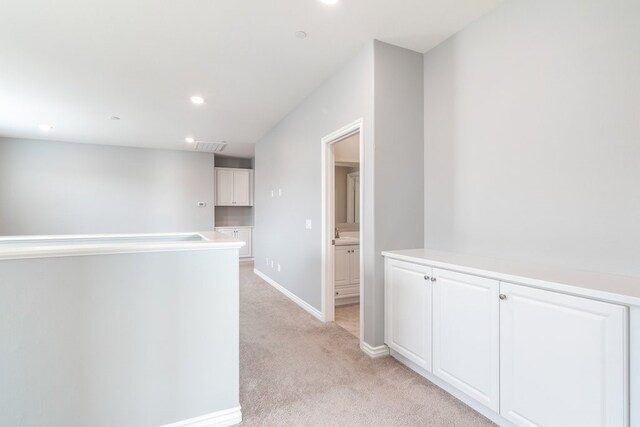 hallway featuring light carpet