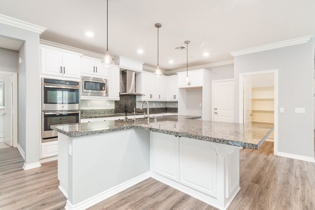 kitchen featuring white cabinetry, appliances with stainless steel finishes, and a spacious island