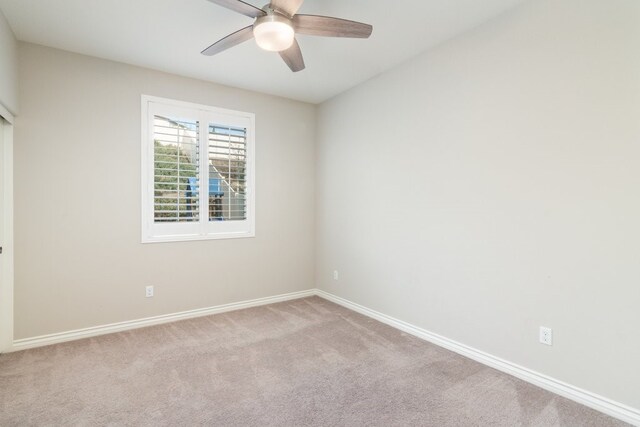 carpeted empty room featuring ceiling fan