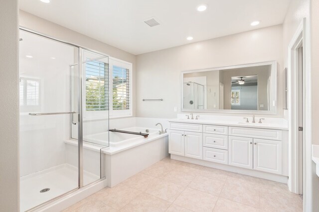 bathroom with separate shower and tub, vanity, and a wealth of natural light