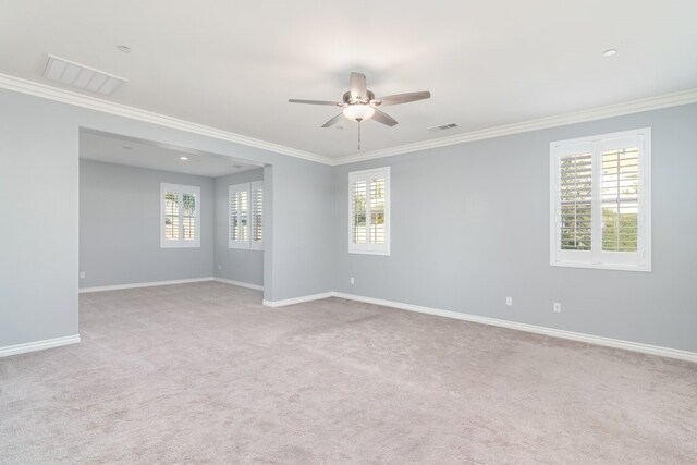 unfurnished room featuring ceiling fan, ornamental molding, and plenty of natural light