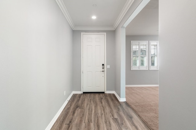 entryway with hardwood / wood-style flooring and crown molding