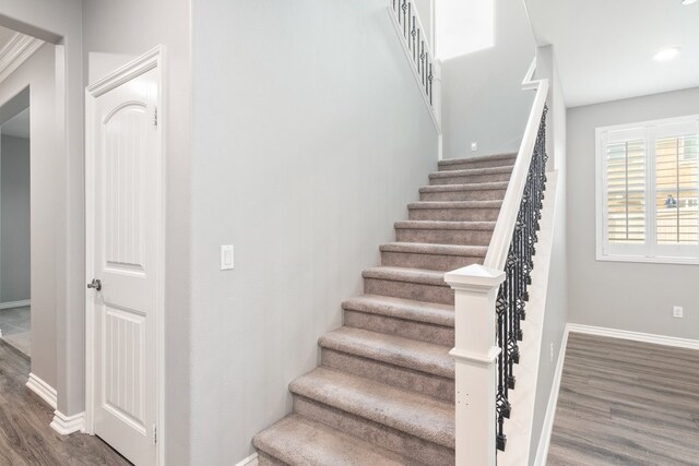 staircase featuring hardwood / wood-style flooring