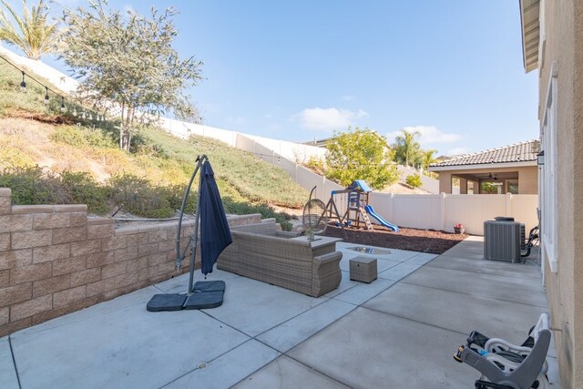 view of patio featuring a playground and cooling unit