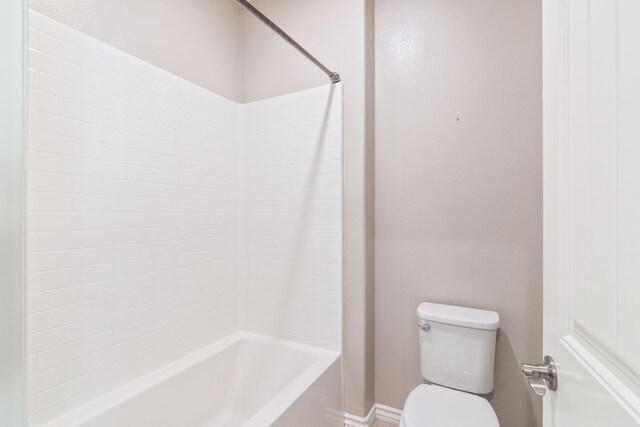 bathroom with shower / bathing tub combination and toilet