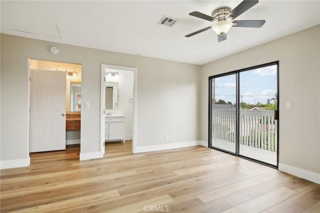 unfurnished bedroom featuring ensuite bath, access to outside, light hardwood / wood-style floors, and ceiling fan