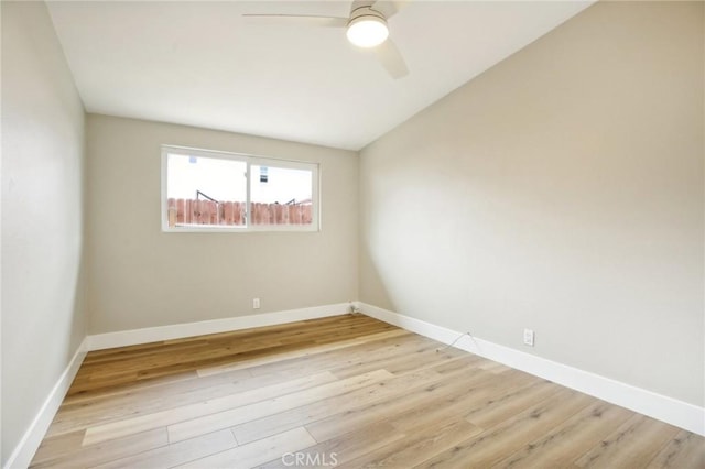 spare room featuring ceiling fan, lofted ceiling, and light hardwood / wood-style floors