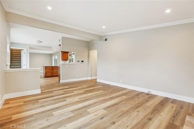 unfurnished living room featuring crown molding and light wood-type flooring