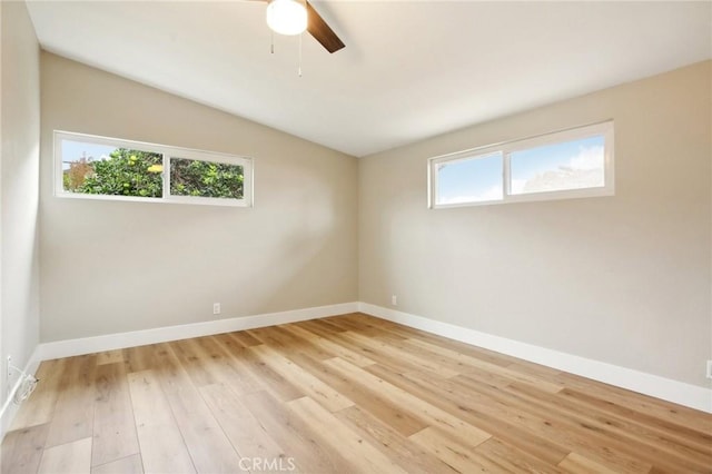 spare room with ceiling fan, lofted ceiling, and light hardwood / wood-style floors