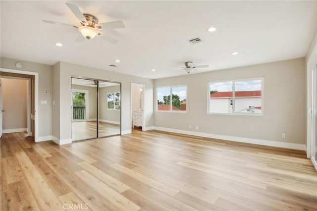 unfurnished bedroom with ceiling fan and light hardwood / wood-style flooring