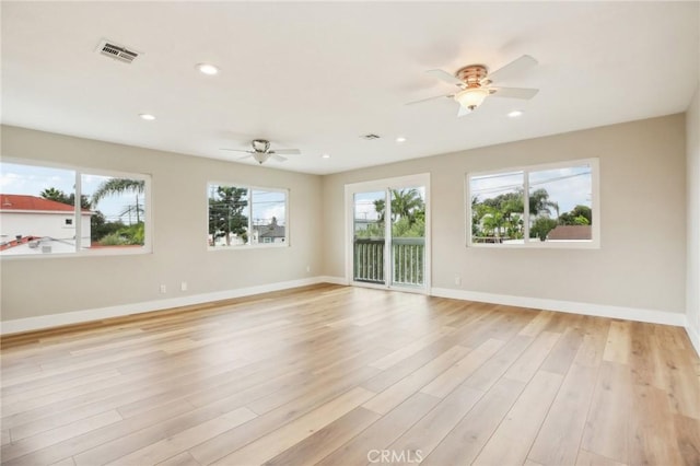 unfurnished room with ceiling fan and light hardwood / wood-style floors