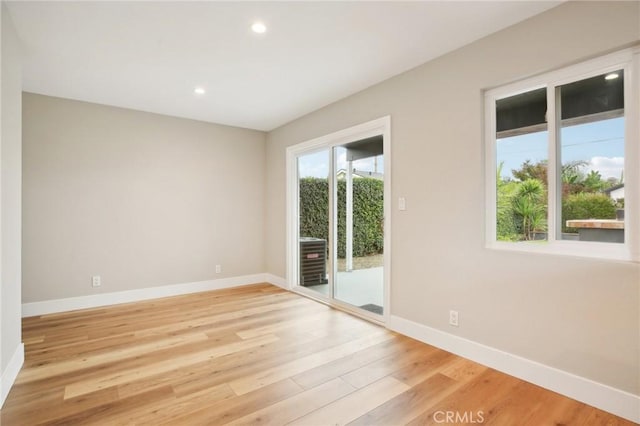 spare room featuring light wood-type flooring