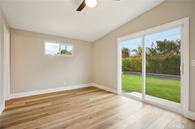 spare room featuring vaulted ceiling, ceiling fan, and light wood-type flooring