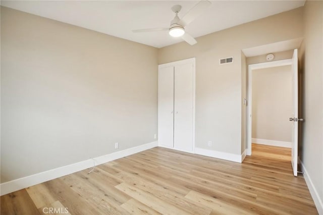 unfurnished bedroom with ceiling fan and light hardwood / wood-style flooring