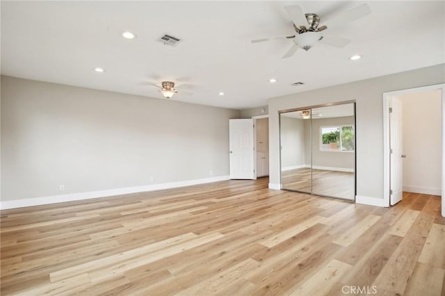 unfurnished bedroom with ceiling fan and light hardwood / wood-style floors