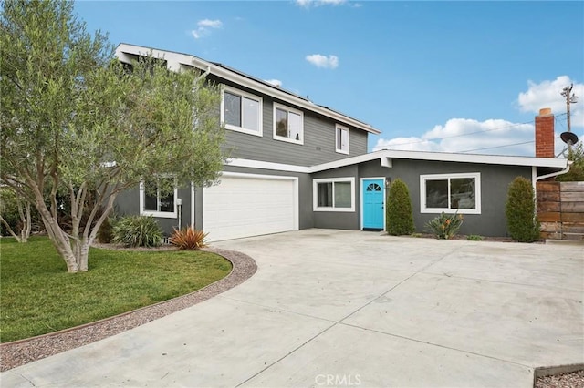 view of front facade featuring a garage and a front lawn