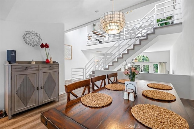 dining room with hardwood / wood-style floors and a chandelier