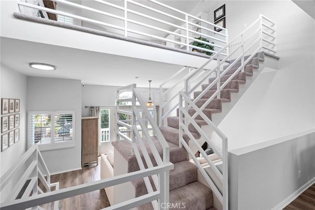 stairs featuring hardwood / wood-style floors