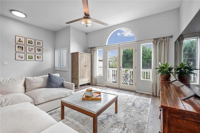 living room with hardwood / wood-style flooring, ceiling fan, and french doors