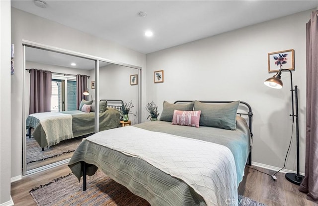 bedroom with wood-type flooring and a closet