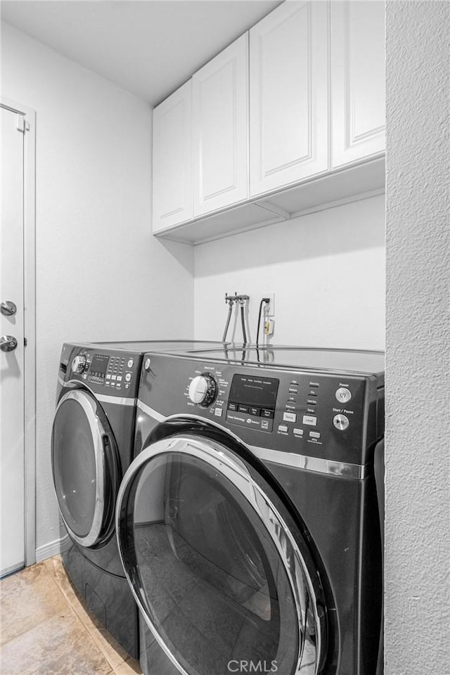 laundry room featuring cabinets and separate washer and dryer