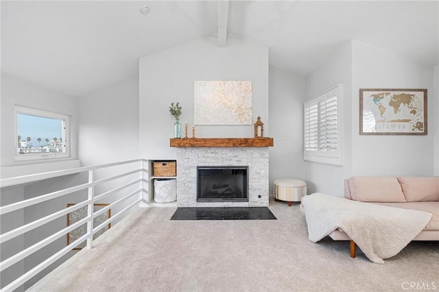 carpeted living room with a fireplace and vaulted ceiling with beams