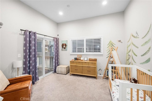 bedroom featuring light colored carpet and access to outside