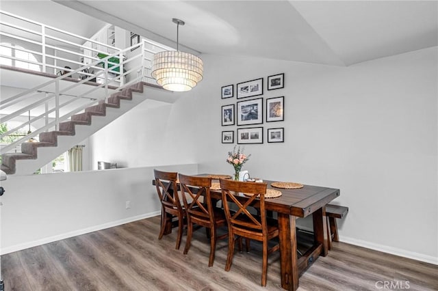 dining room featuring hardwood / wood-style flooring and lofted ceiling