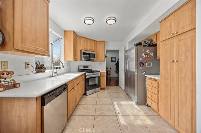 kitchen with sink, light tile patterned floors, and stainless steel appliances