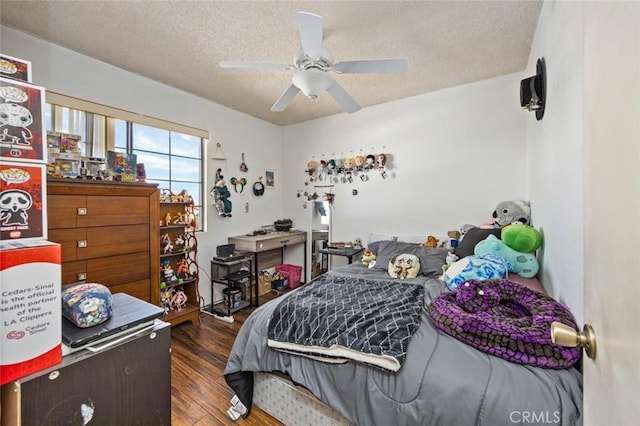 bedroom featuring ceiling fan, dark wood-type flooring, and a textured ceiling