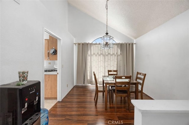 dining room featuring vaulted ceiling, dark hardwood / wood-style floors, a notable chandelier, and a textured ceiling