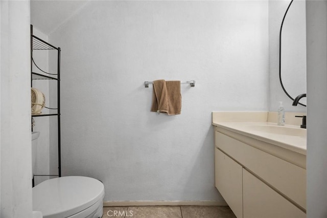 bathroom with tile patterned floors, vanity, and toilet