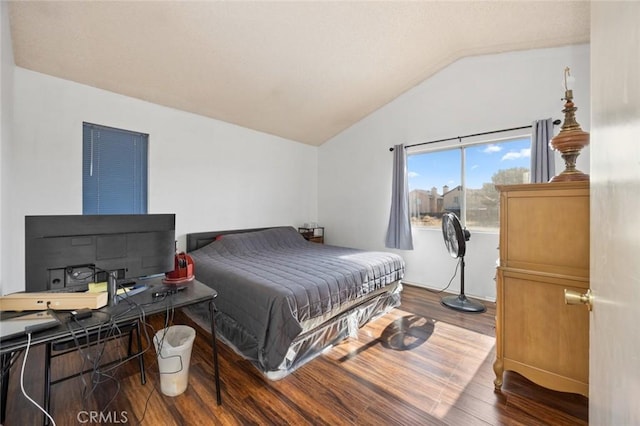 bedroom featuring hardwood / wood-style flooring and lofted ceiling