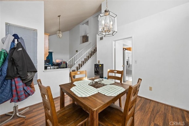 dining area featuring dark wood-type flooring and a chandelier