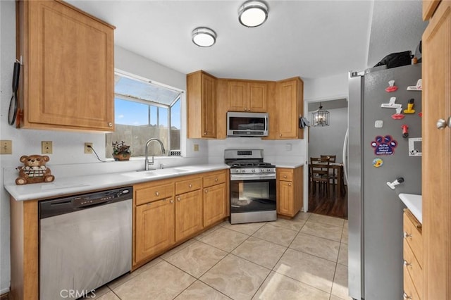 kitchen featuring stainless steel appliances, light tile patterned flooring, and sink