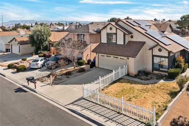 view of front of house featuring a garage and solar panels