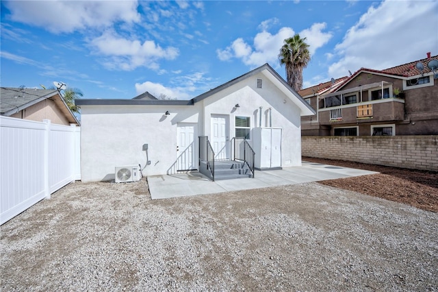 back of property with a patio and ac unit