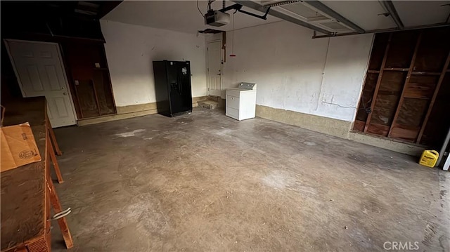 garage featuring a garage door opener and washer / dryer