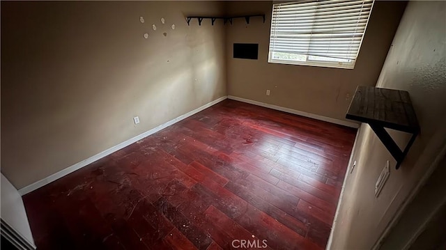 unfurnished room with wood-type flooring