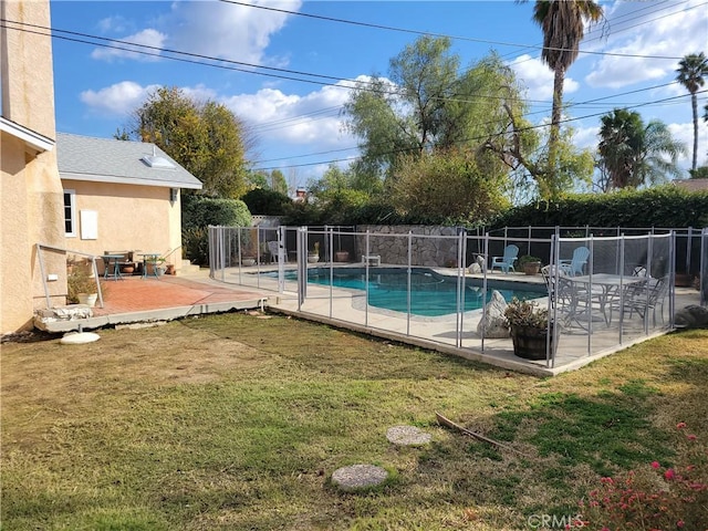 view of swimming pool featuring a patio area and a lawn