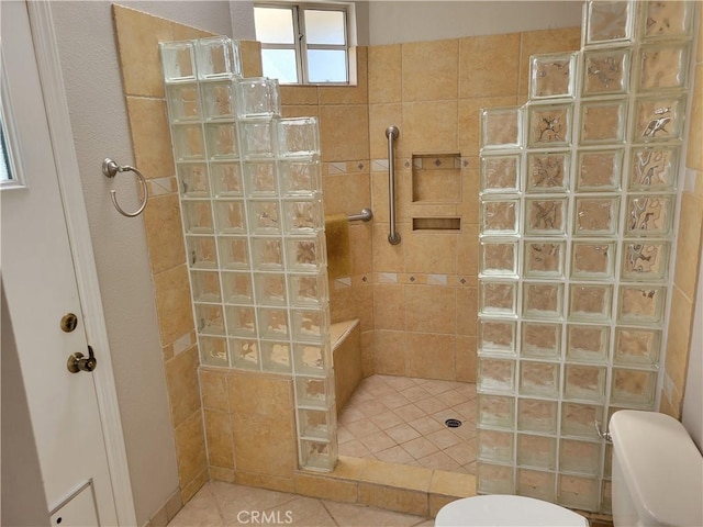 bathroom with tile patterned flooring and tiled shower