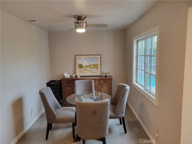 dining room with ceiling fan and light tile patterned flooring