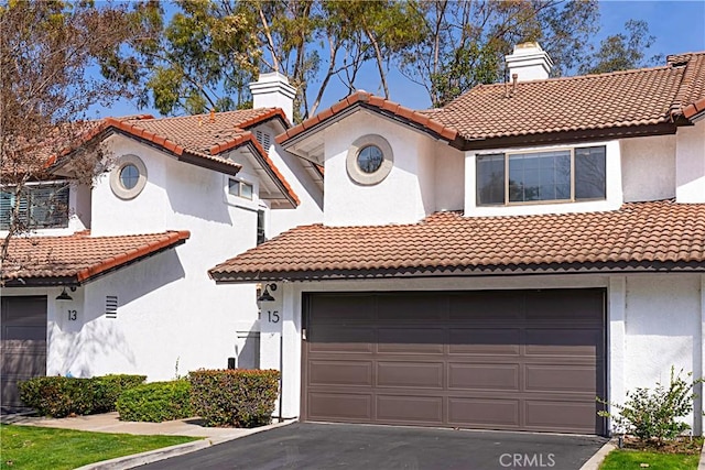 mediterranean / spanish house featuring a garage