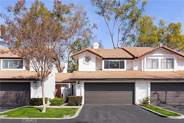 mediterranean / spanish-style home featuring a garage