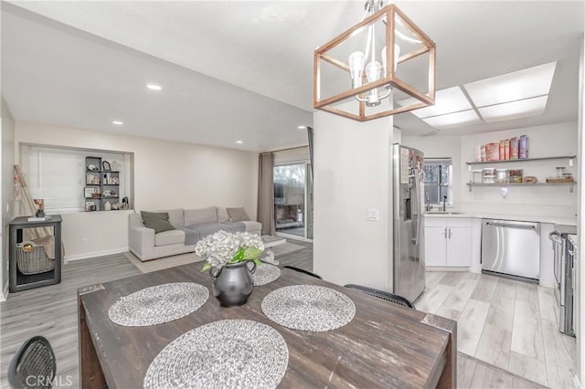 dining room with an inviting chandelier and light hardwood / wood-style flooring