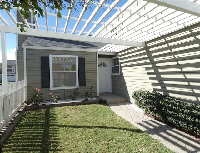 doorway to property with a yard and a pergola