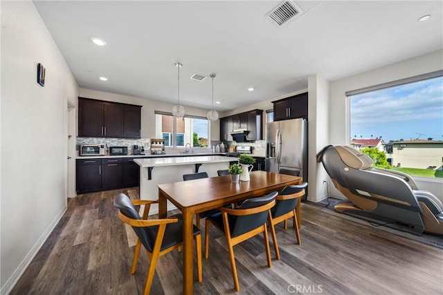 dining area featuring sink and hardwood / wood-style floors